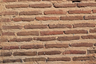 Close-up of masonry work on a rustic brick wall.