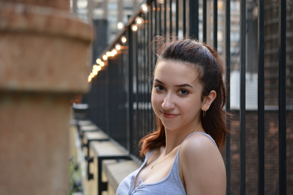 shallow focus photo of woman in gray spaghetti strap top