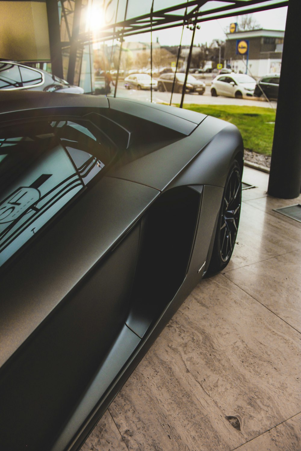 black car on brown surface across cars