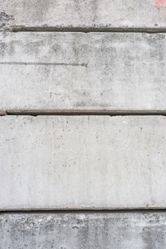 Various concrete samples showing different textures and colors arranged on a table.