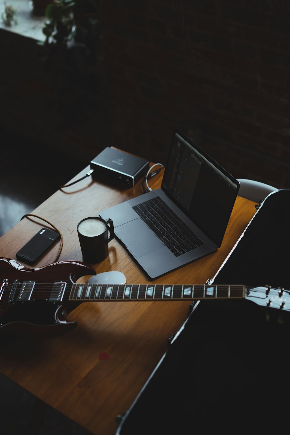 silver MacBook on brown wooden table