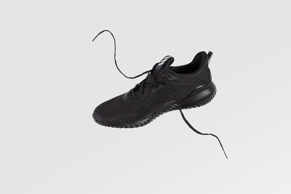 unpaired black low-top sneaker