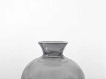 A clear glass vase showcasing minimalist modern design with clean lines and subtle curves.