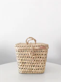 Woven storage bin with natural fibers and earth-tone hues.