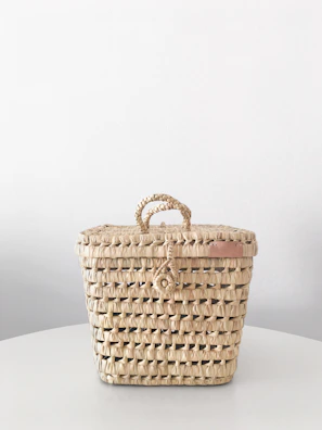 Woven storage bin with natural fibers and earth-tone hues.