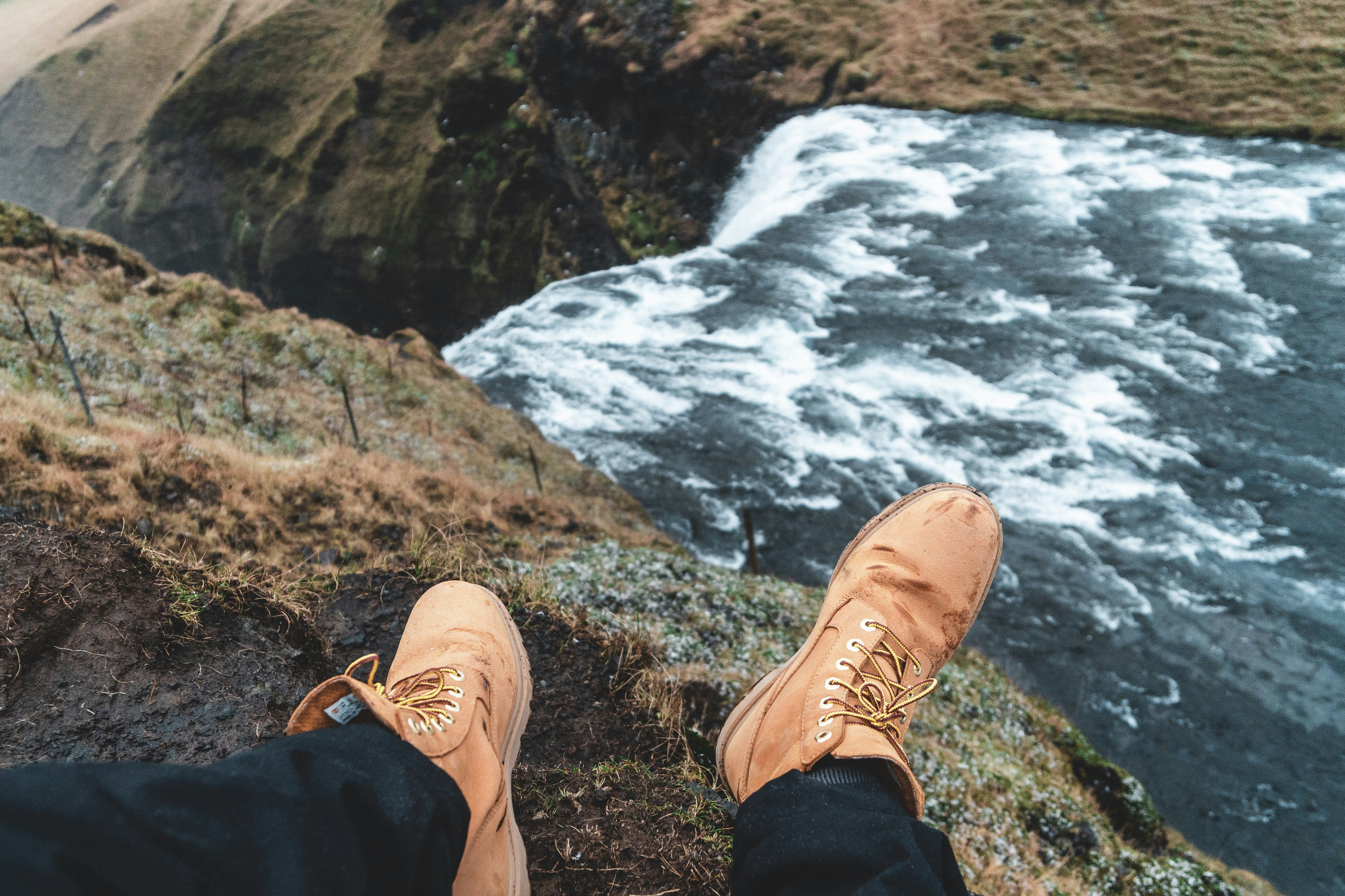 man sitting on mountain peak