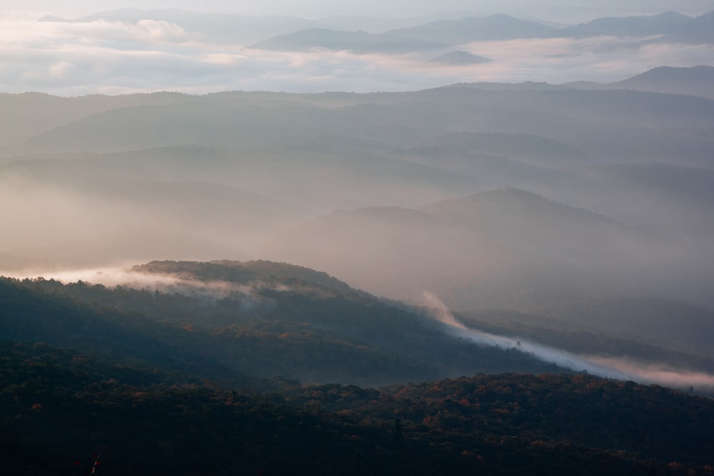 a view of a mountain range covered in fog