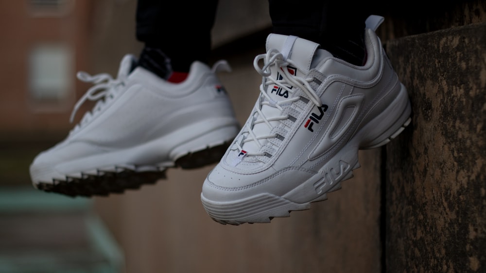 Man Wearing Pair Of White Shoes Sitting On Bench Photo Free