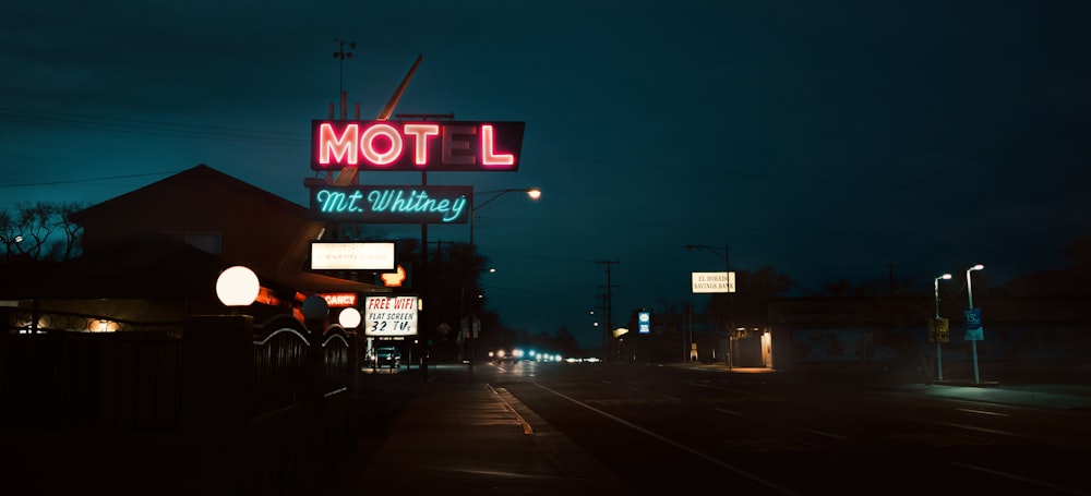 turned-on neon Motel sign at the street