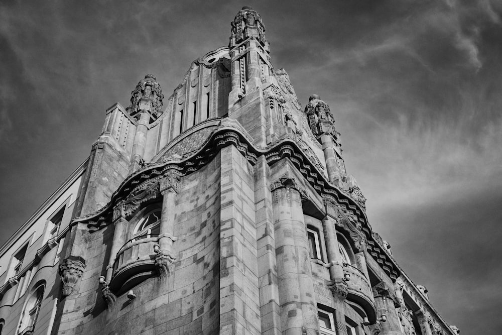 grayscale photo of concrete building under cloudy sky