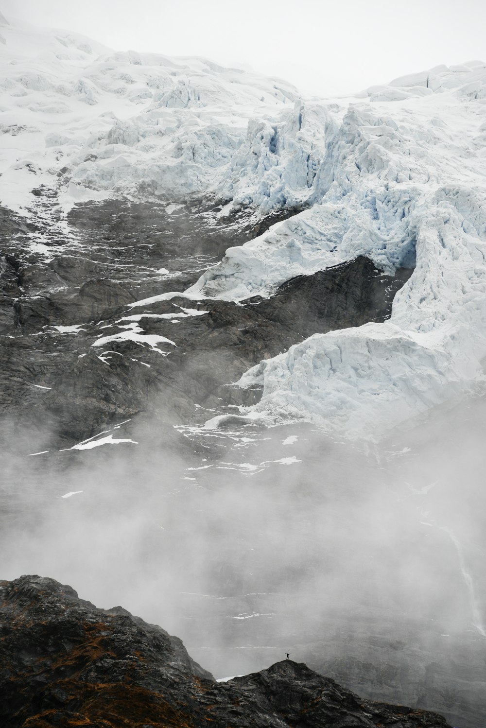 mountains covered with snow and fog