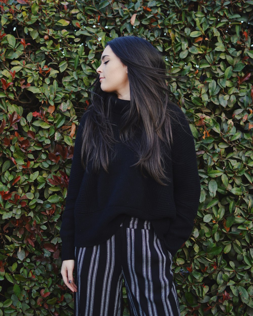 woman wearing black jacket near wall