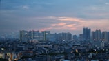 Sunset skyline of a bustling urban area with high-rise buildings.