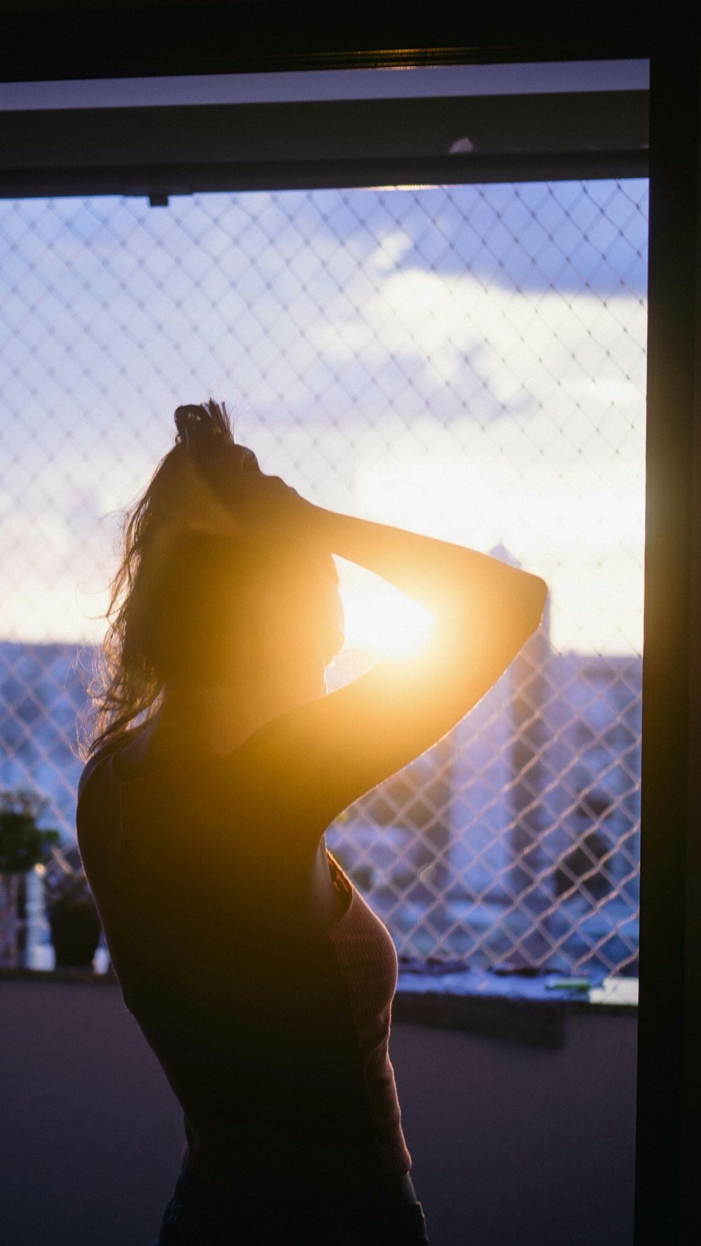 woman standing near closed window