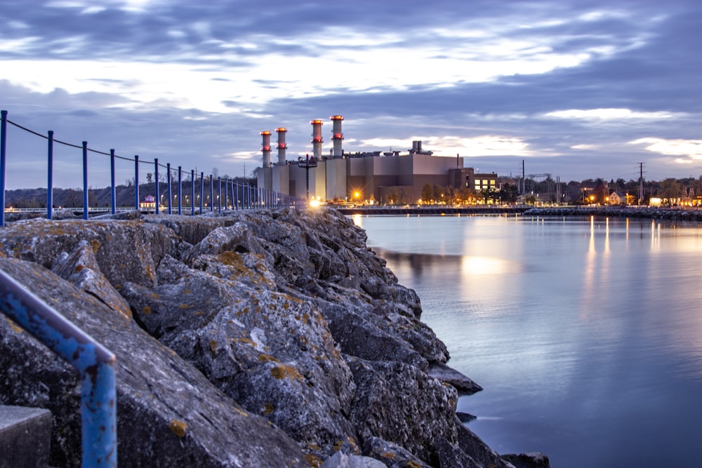 body of water near buildings under cloudy sky landscape photo