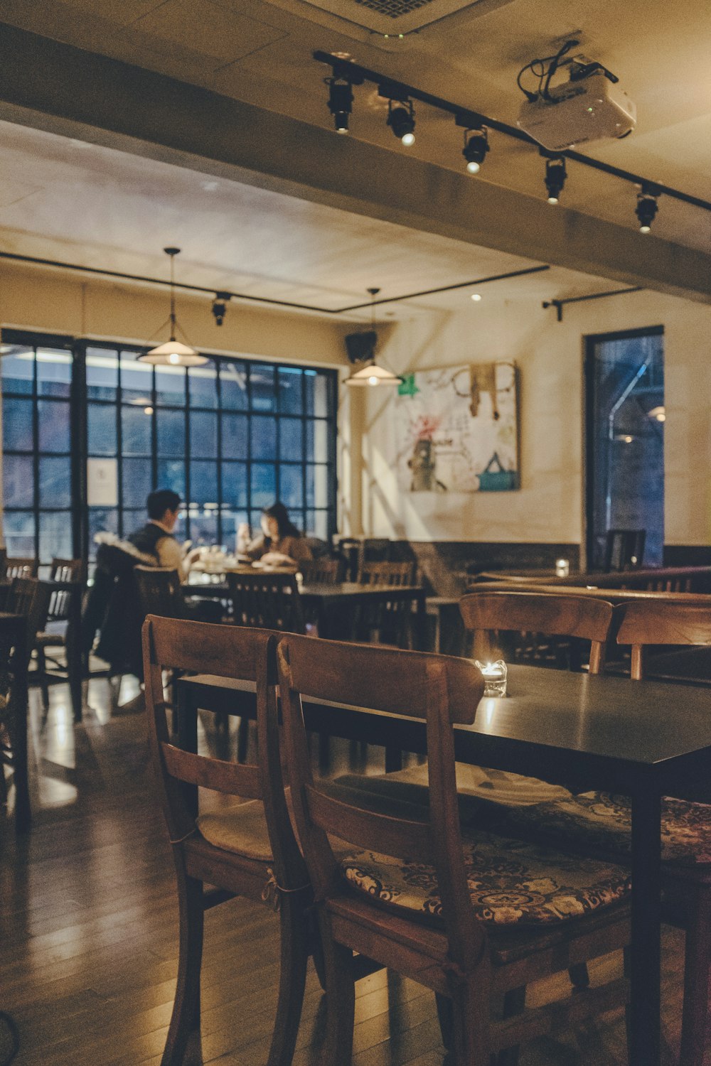 man and woman dining with lights turned-on