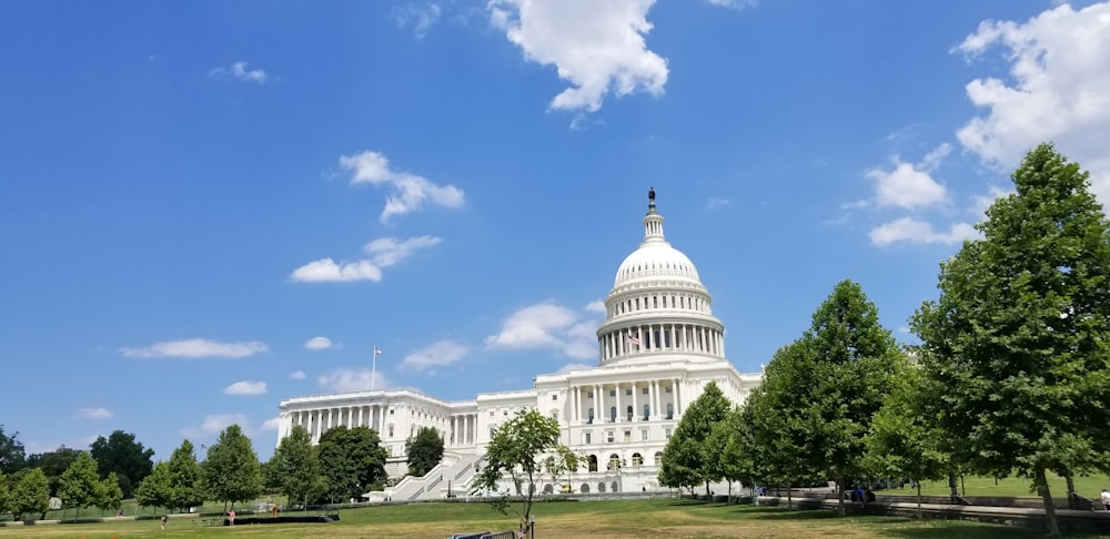 white concrete dome building under blue sky