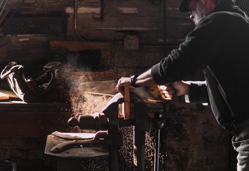 Working the pine — hand-sawing in the workshop
