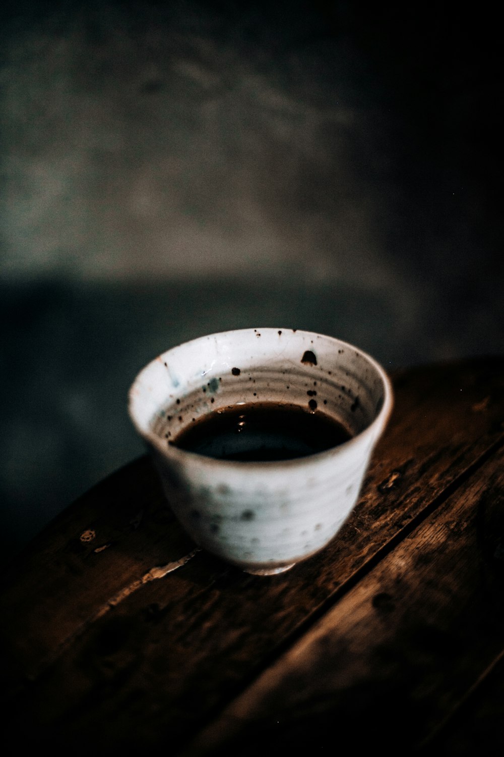 white ceramic bowl on brown wooden table