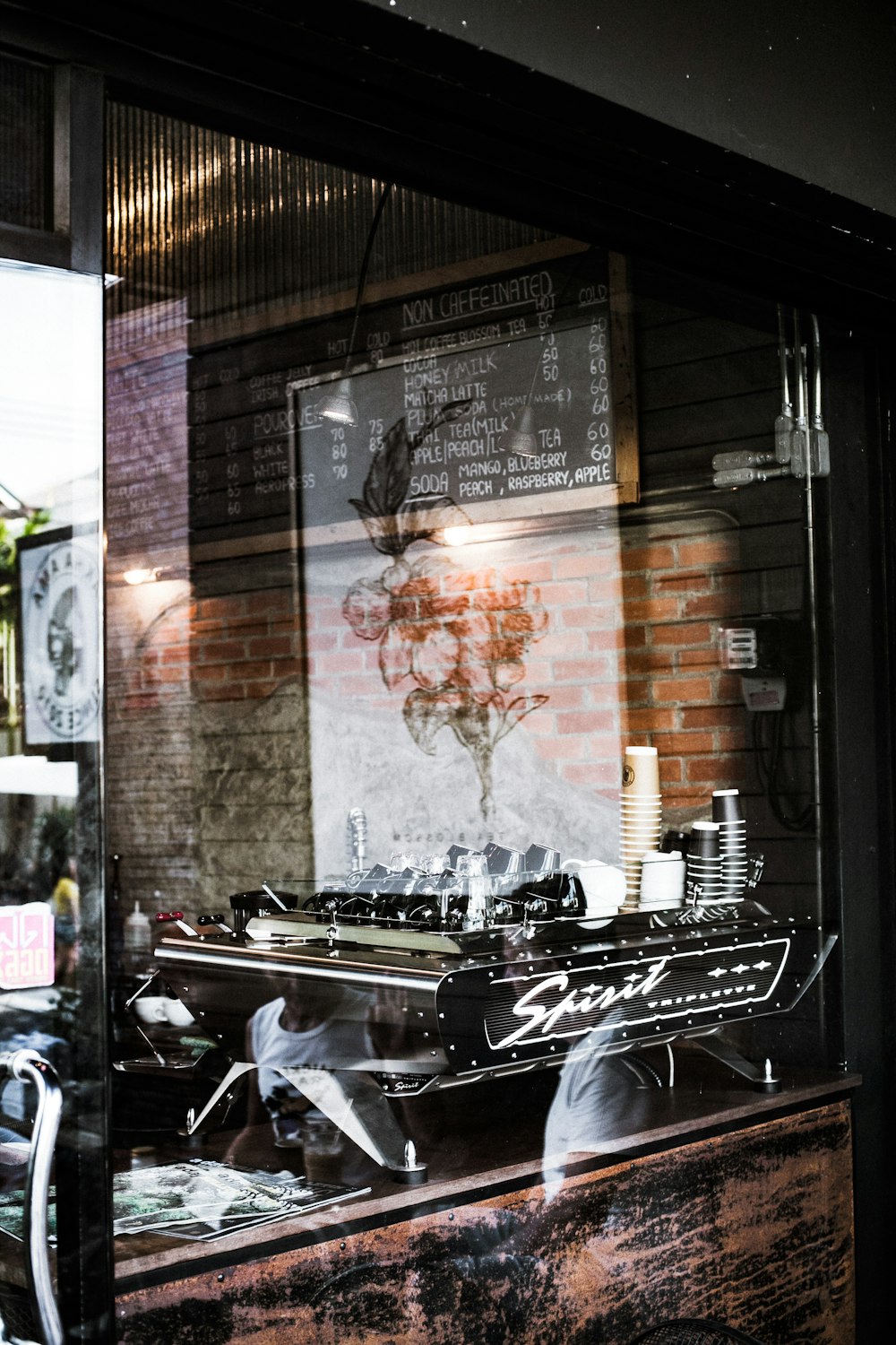 a store front window with a bike in the reflection