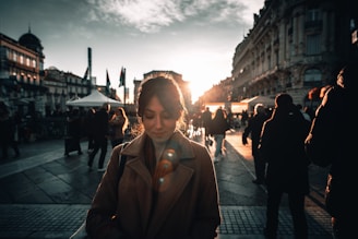 Nina smiling warmly against a backdrop of a bustling city street, embodying confidence and curiosity.
