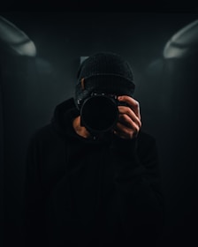 person holding DSLR camera