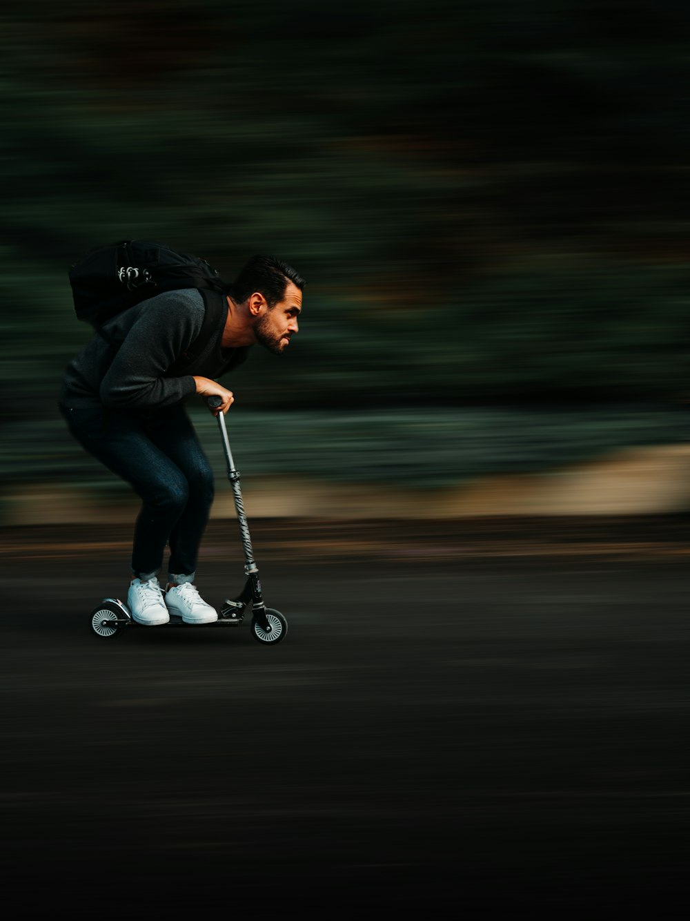 man riding kick scooter with fast speed