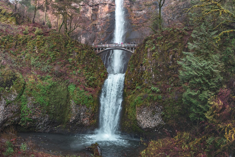gray bridge over waterfalls