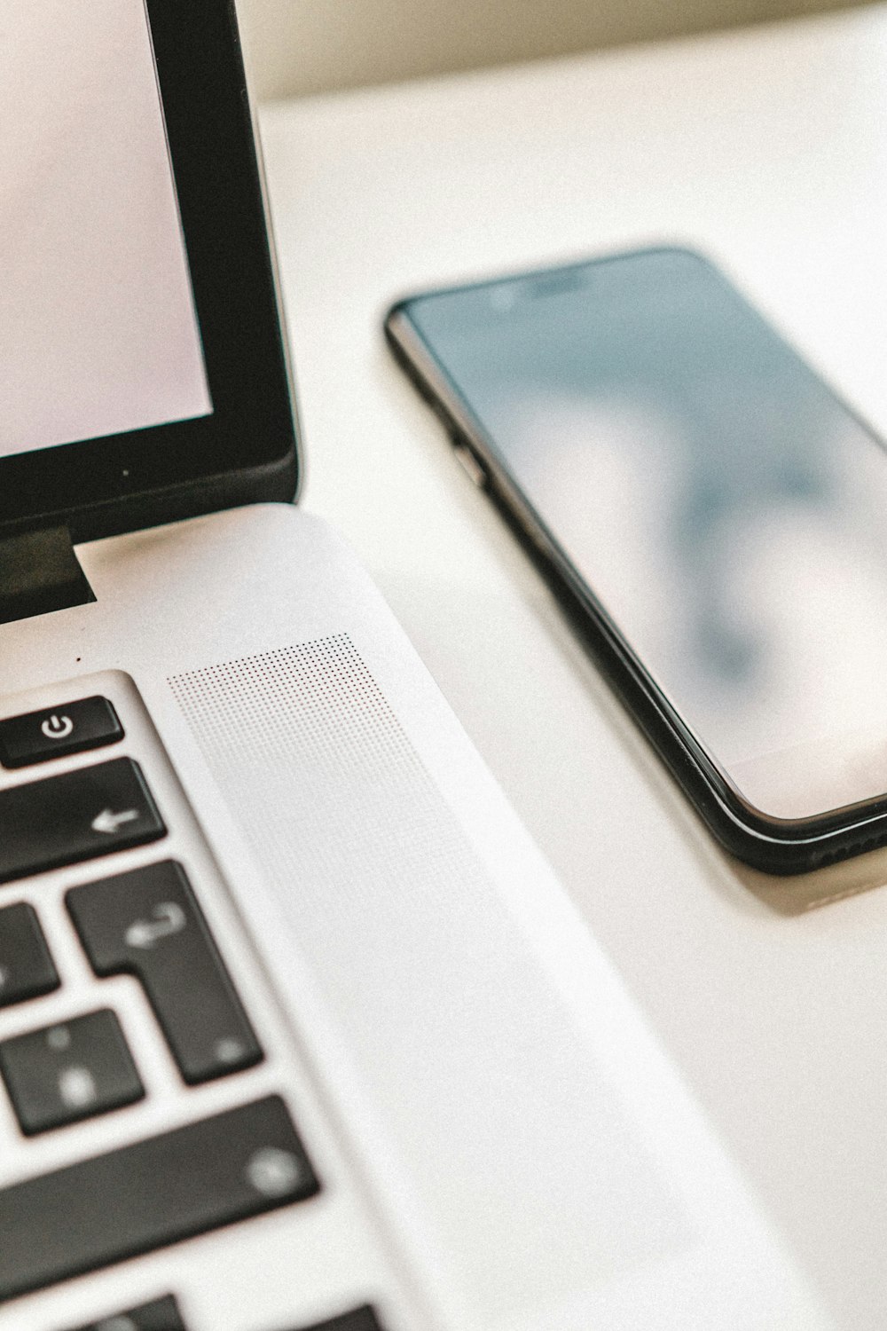 laptop computer beside phone