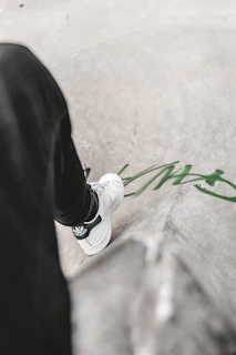 Urban sneaker shot on concrete steps with graffiti walls in the background.