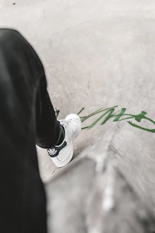 Urban sneaker shot on concrete steps with graffiti walls in the background.