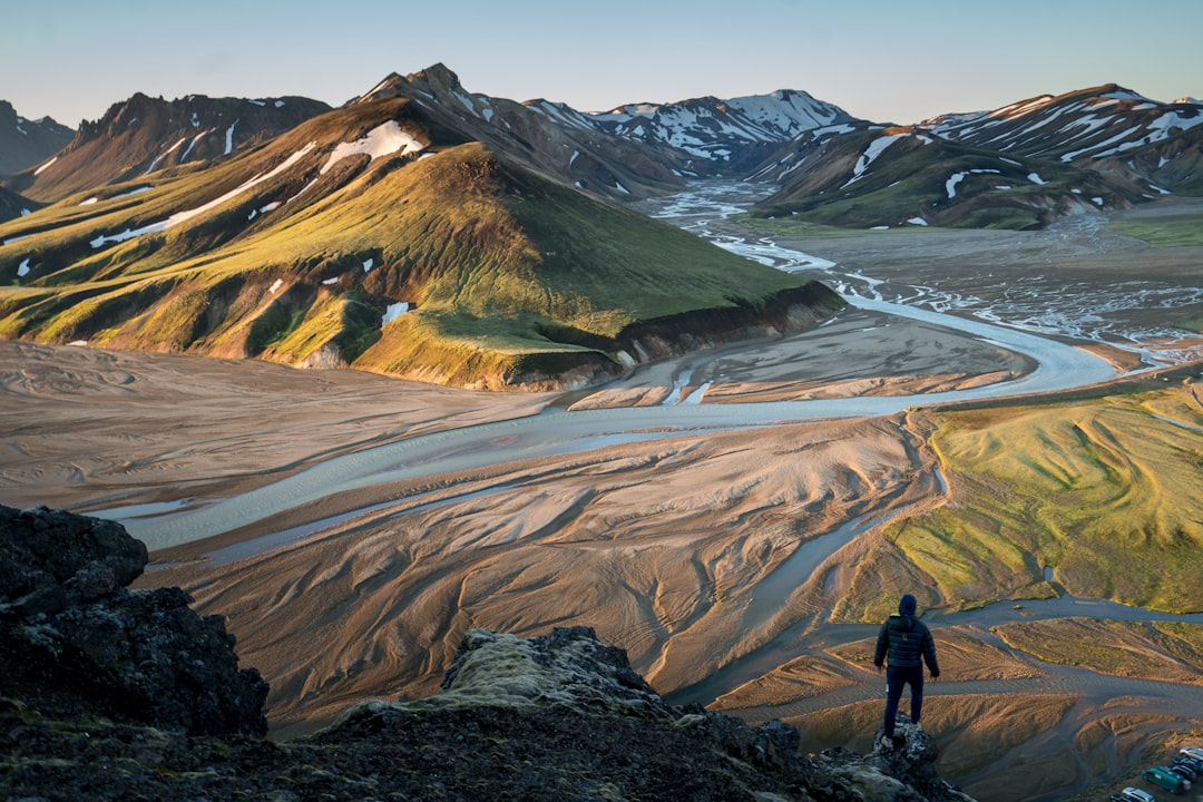 man standing on the edge of a cliff, Hundreds of miles with nothing but your backpack and a change of clothes. Would you