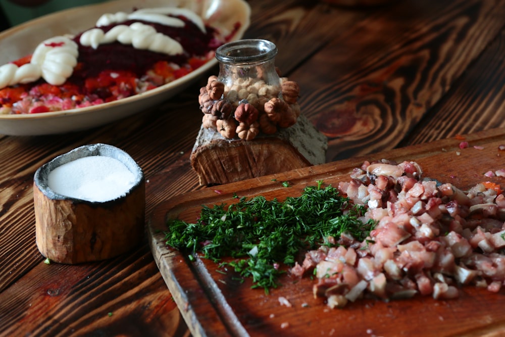 slice of meat and greens on chopping board