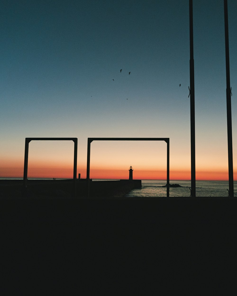 silhouette of empty dock in front sea