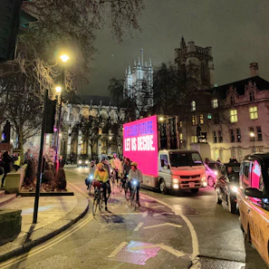 Evening shot of the beer bike illuminated by warm lights, surrounded by happy riders.