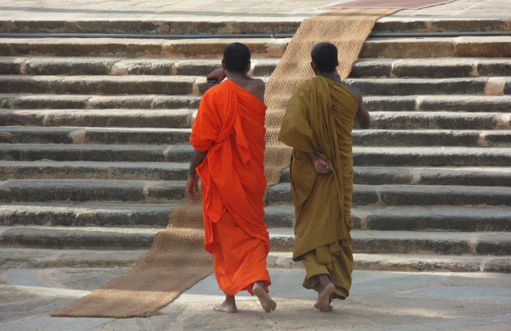 Buddhist monks wearing orange and yellow robes