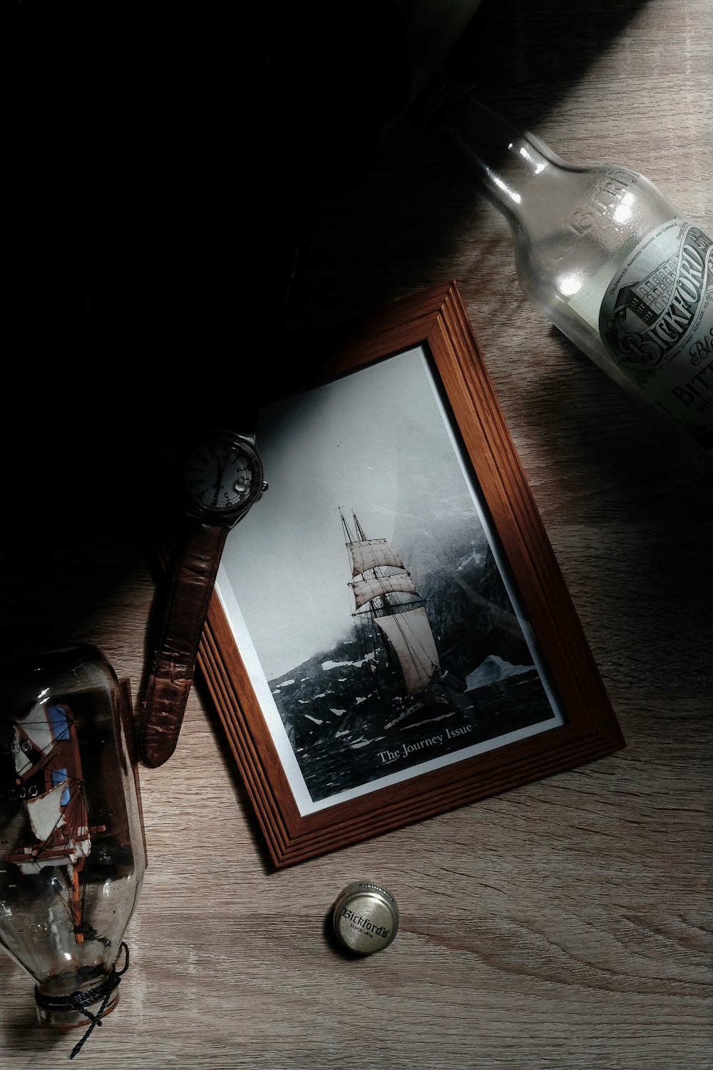 white clipper ship painting with brown wooden frame