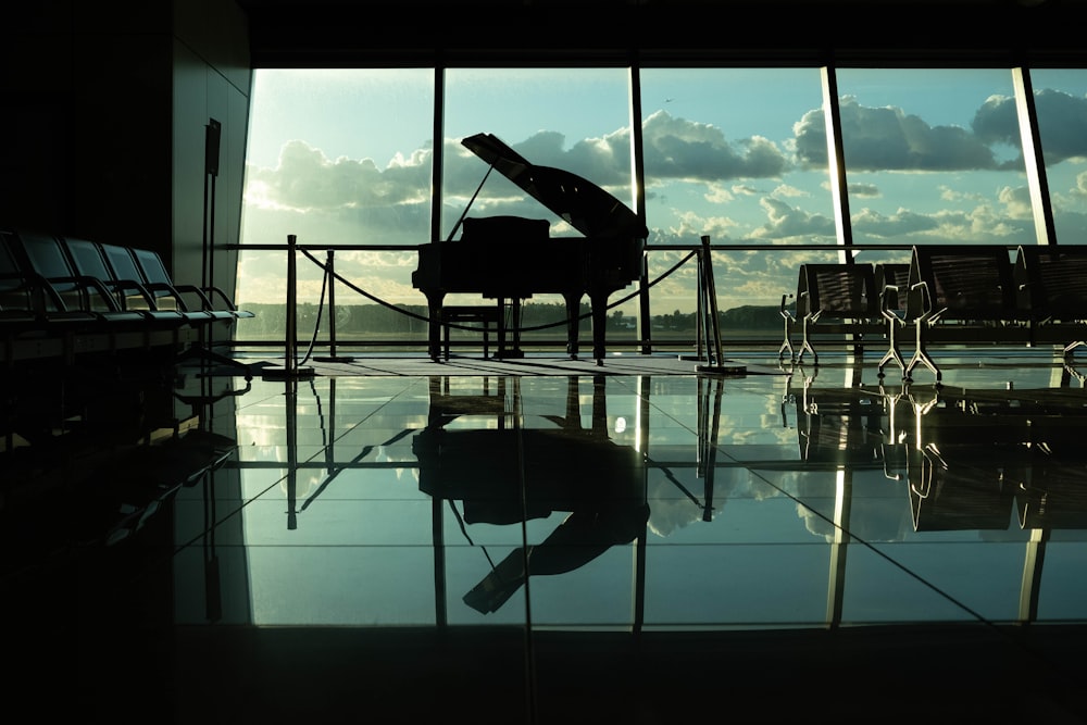 silhouette of grand piano inside building
