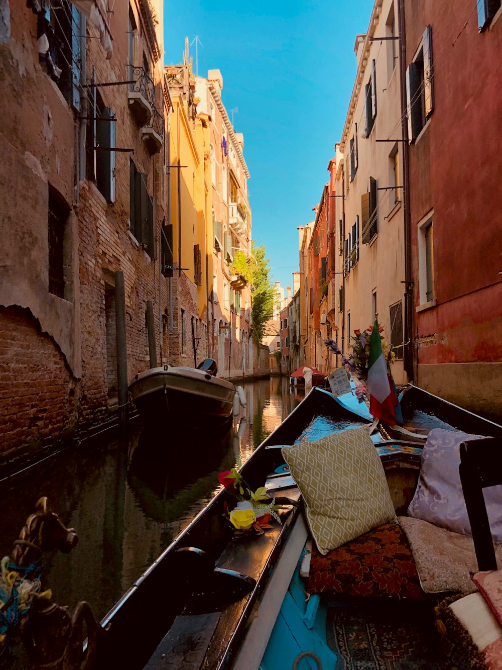 boats in between buildings at daytime