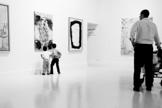 grayscale photography of two boys looking painting
