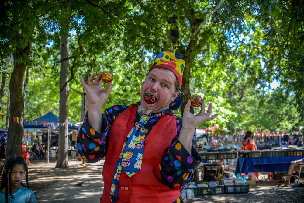 man holding two balls and one ball on his mouth