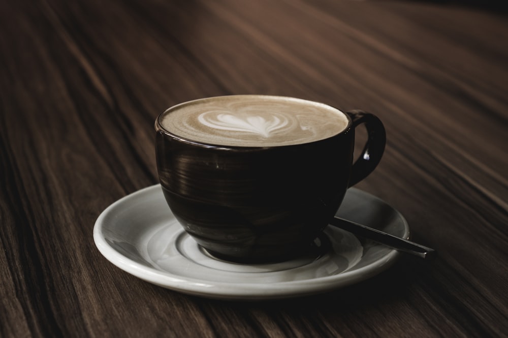 one cup of cappuccino on desk