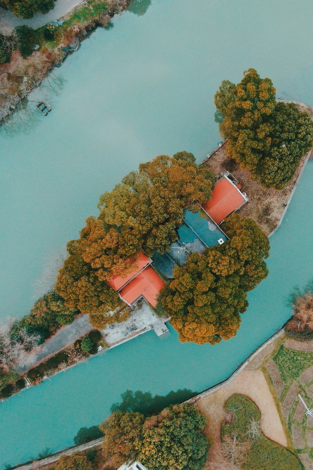 aerial photo of house with red roof in an islet