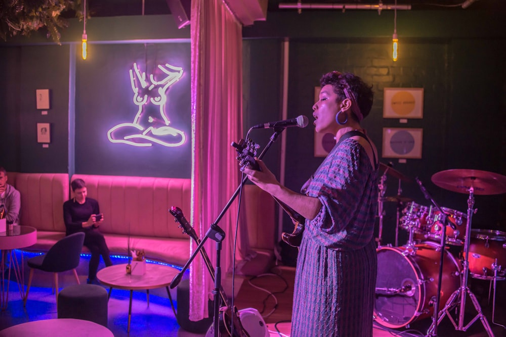 woman singing while playing guitar