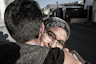 woman hugging man beside street during daytime