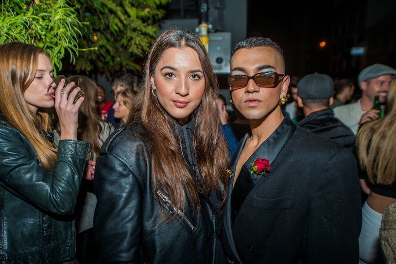 Diverse group of people wearing stylish casual and formal outfits outdoors.