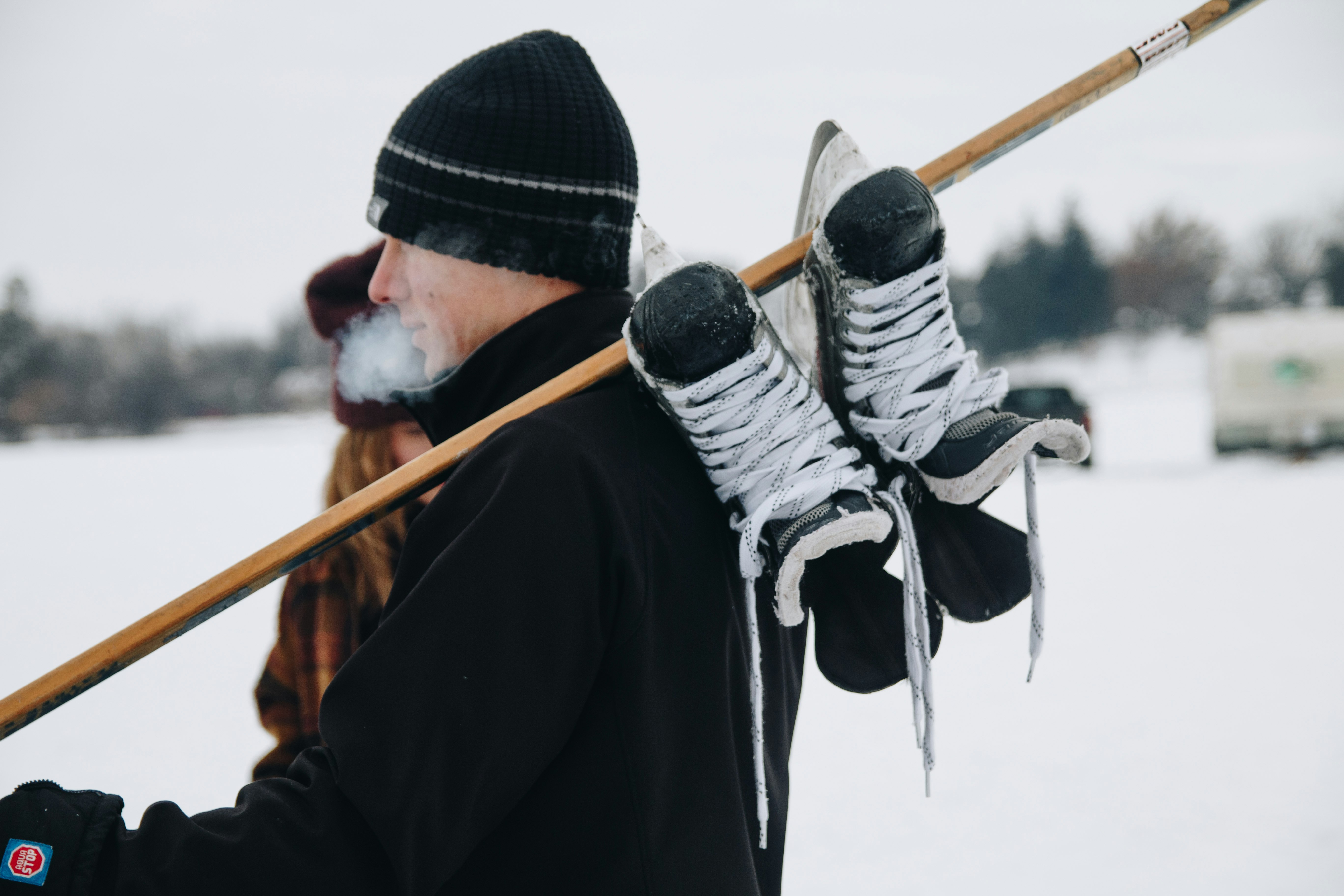 man carrying pair of snow shoes