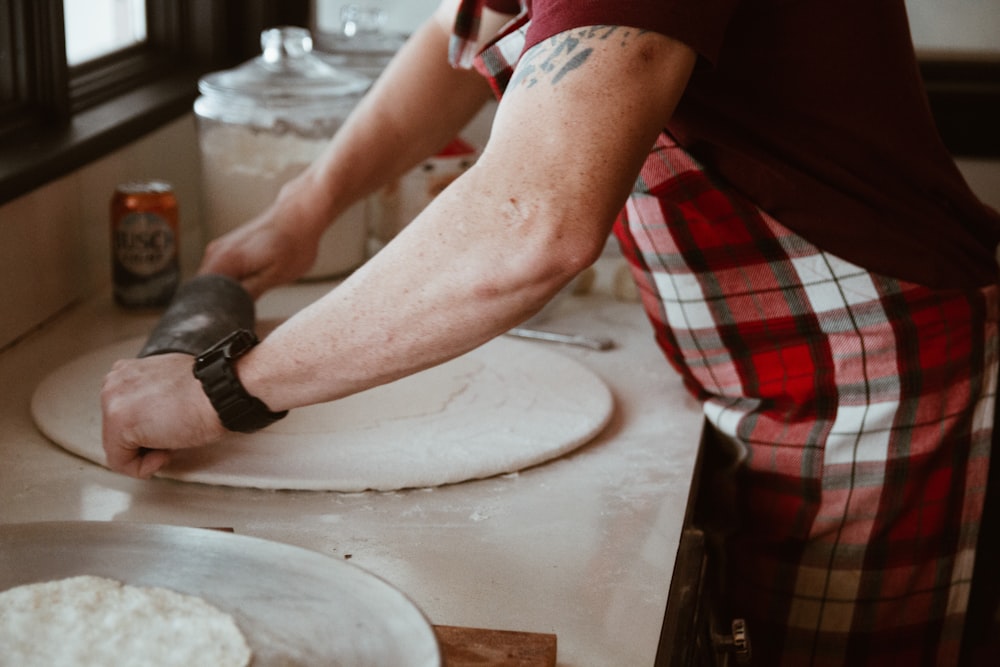 man holds black rolling pin