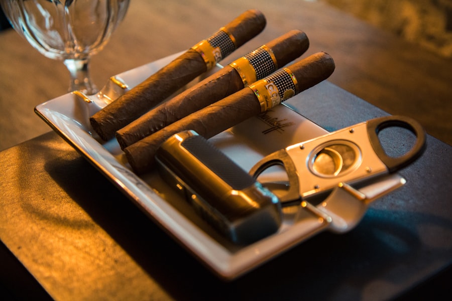 Premium cigars and cigar cutter on dark table