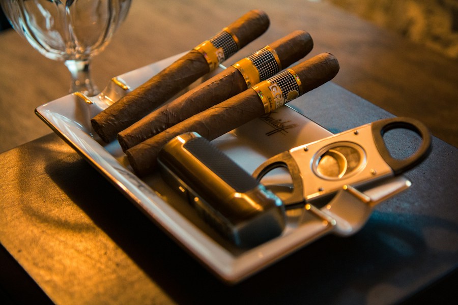 Premium cigars beside a cigar cutter